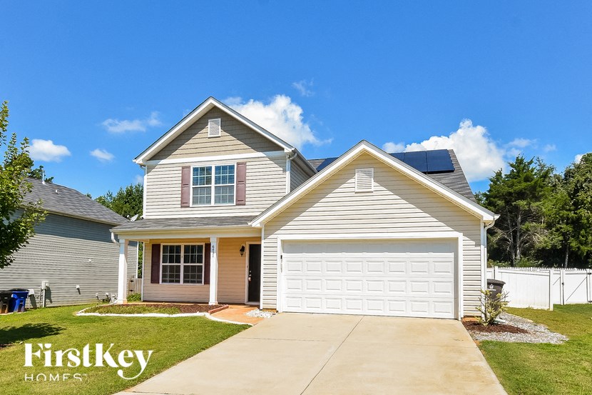 a house with a white garage door and a driveway