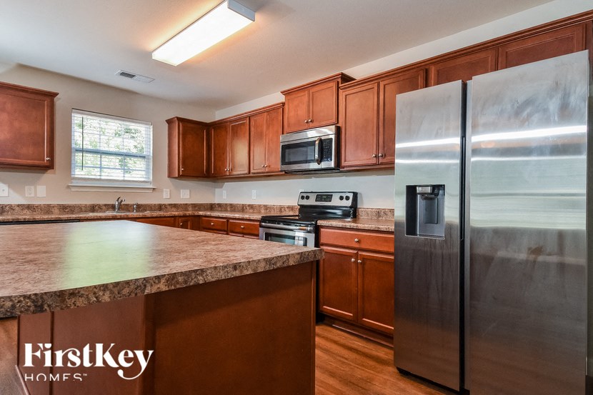 full view of kitchen with stainless steel appliances and granite counter tops
