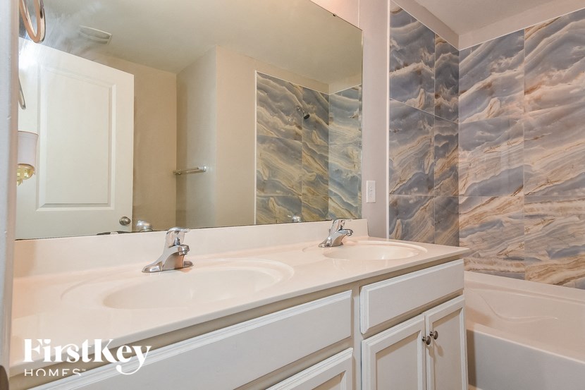 a bathroom with two sinks and a large mirror