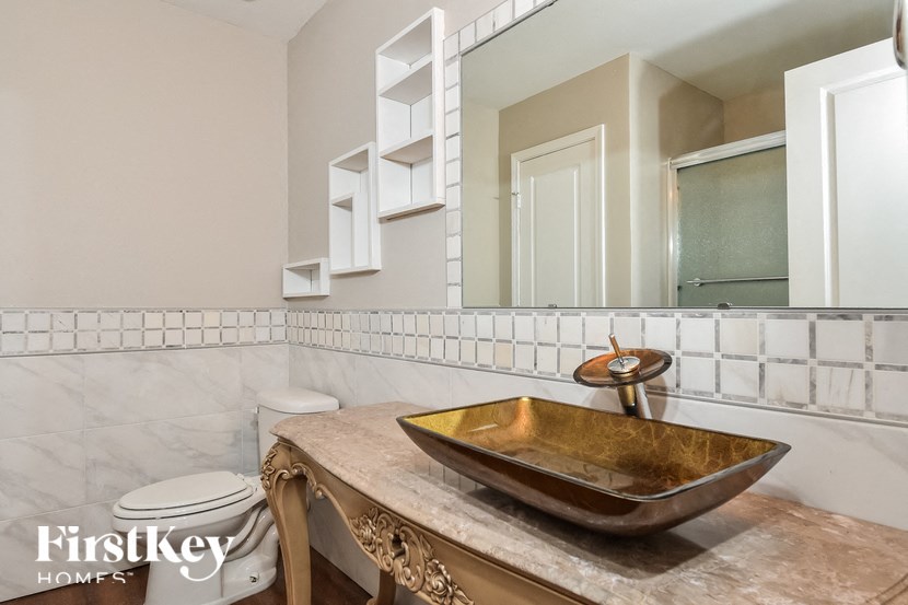 a bathroom with a sink and a mirror and a toilet