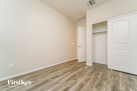 a bedroom with a closet and a door to a wardrobe