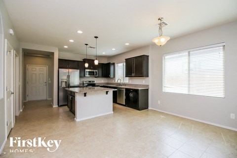 a large kitchen with black cabinets and a white counter top