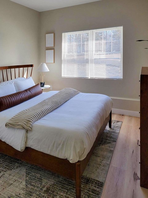 a bedroom with a bed and a window