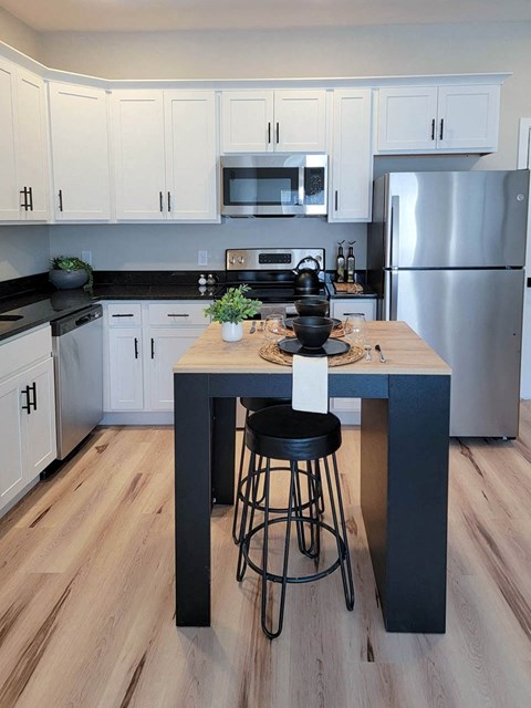 a kitchen with a center island and stainless steel appliances