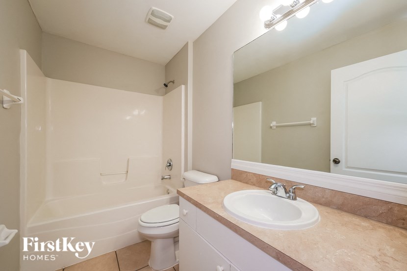 a bathroom with a sink and a toilet and a mirror