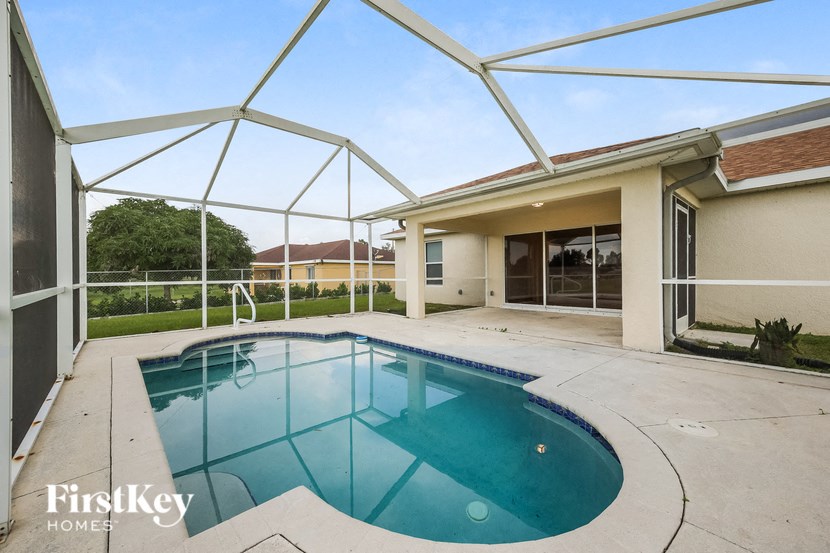 a pool and patio in a house with a pool
