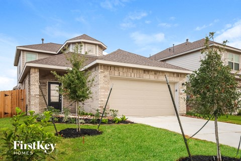 A house with a brown roof and a garage door is for sale.
