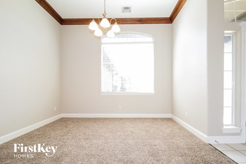 a empty room with a window and a carpeted floor