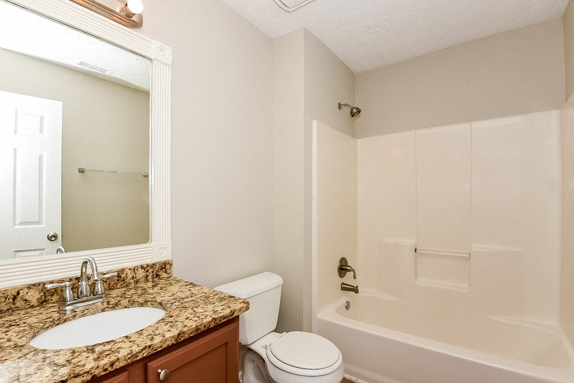 a bathroom with a sink toilet and a shower