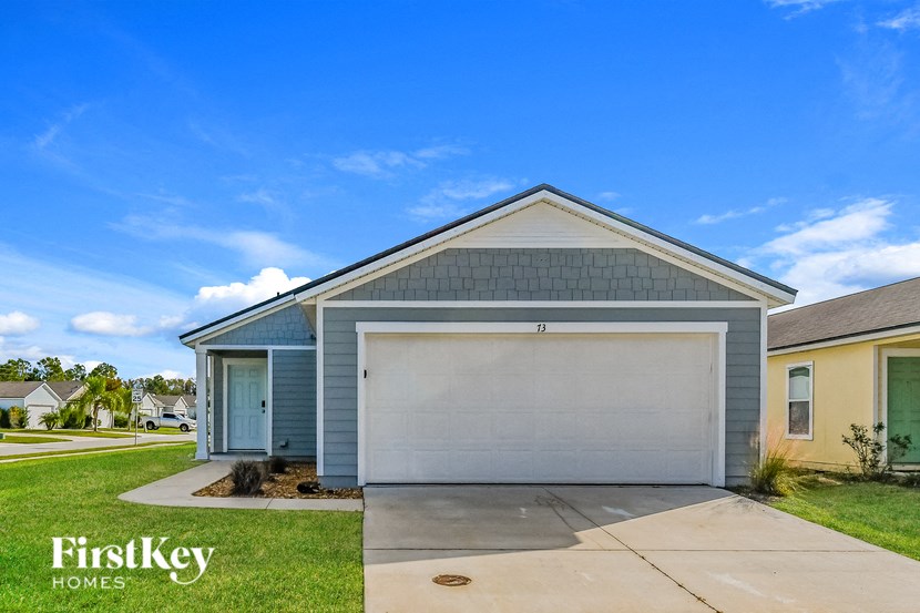 A house with a garage door is for sale by FirstKey Homes.