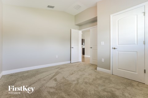 a bedroom with a carpeted floor and white doors