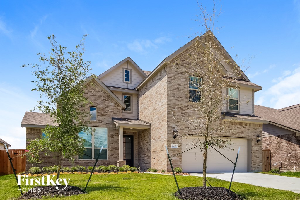A house with a stone facade and a large front yard.