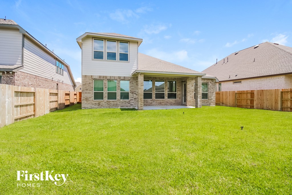 A house with a large lawn in front of it.