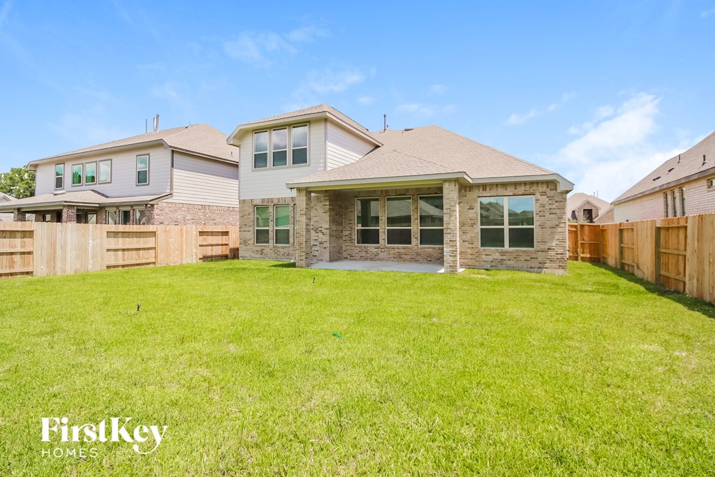 A house with a large lawn in front of it is for sale.