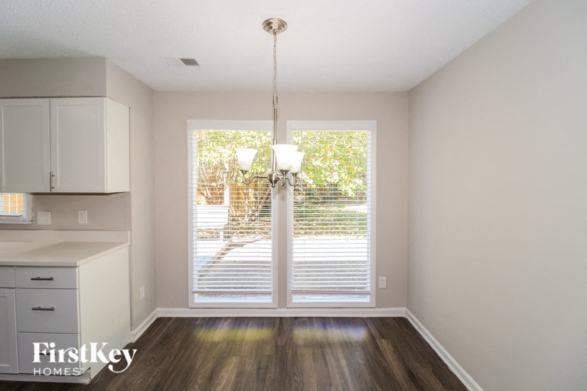 A well lit room with a chandelier and a sliding door.