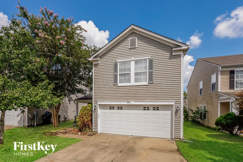 a beige house with a white garage door