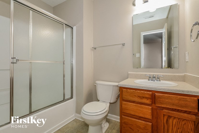 a small bathroom with a shower toilet and sink