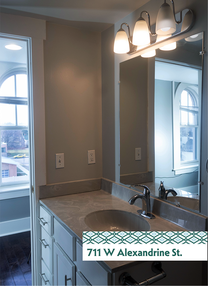 A bathroom with a sink and mirror.