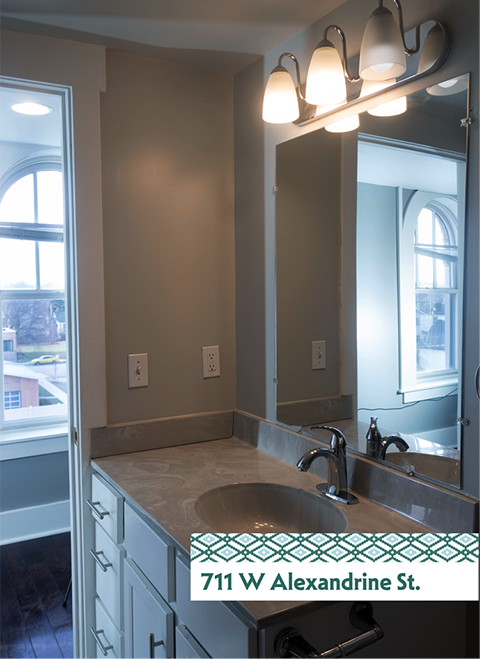A bathroom with a sink and mirror.