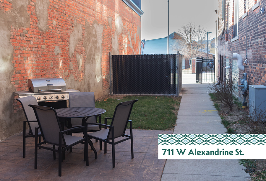 A patio with a grill and chairs is located at 711 W Alexandrine St.