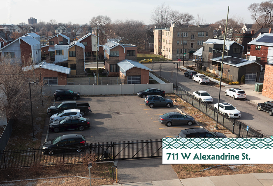 A parking lot with cars and a sign that says 711 W Alexandrine St.