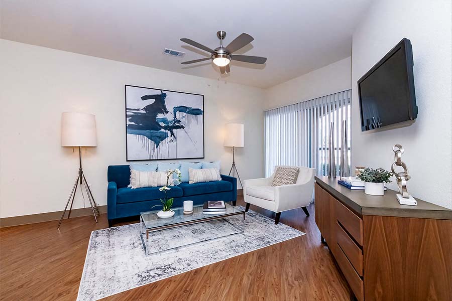 a living room with a blue couch and a tv