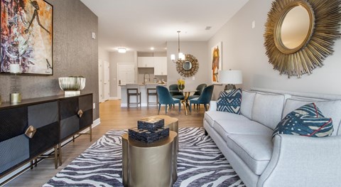 A living room with a white couch and a zebra print rug.