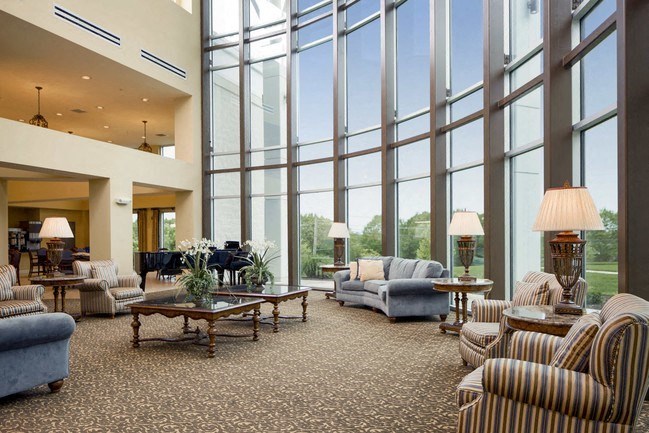 a large lobby with couches and chairs and large windows