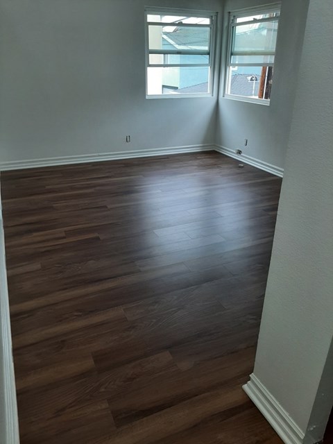 A room with wooden floors and a window.