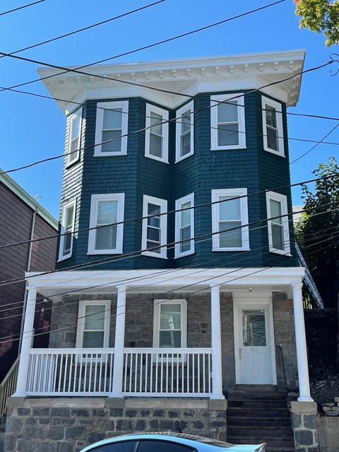 A blue and white two-story house with a white porch.