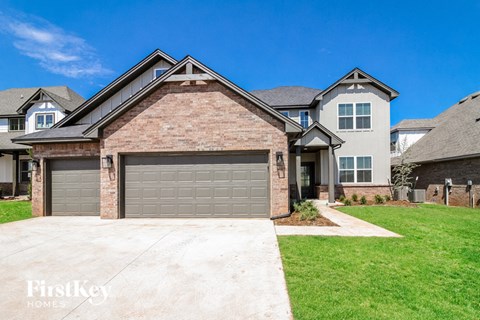 a garage door on a brick house with a green lawn