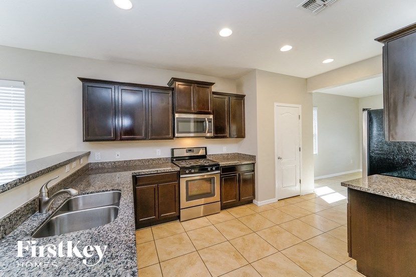 a kitchen with wood cabinets and granite counter tops and a sink