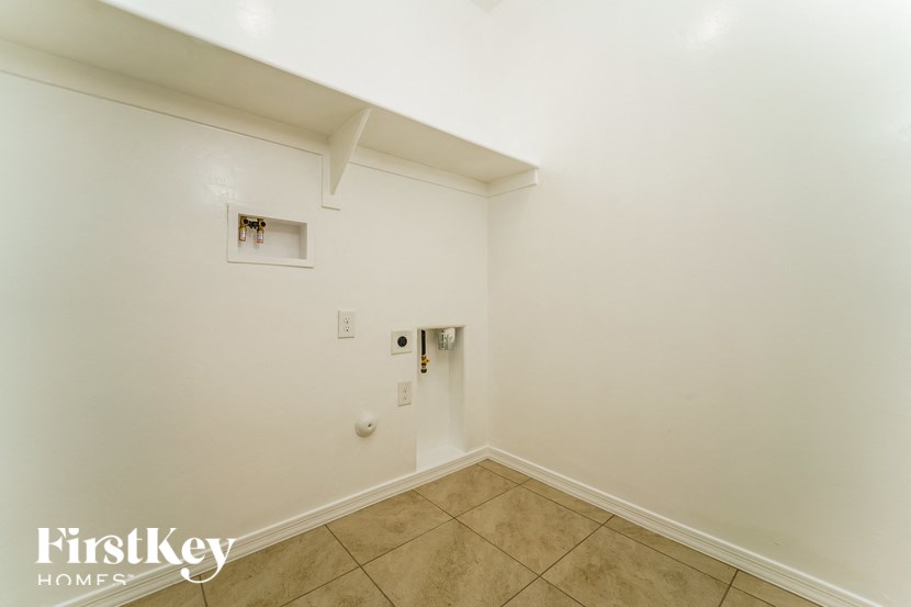 a empty room with a tile floor and white walls