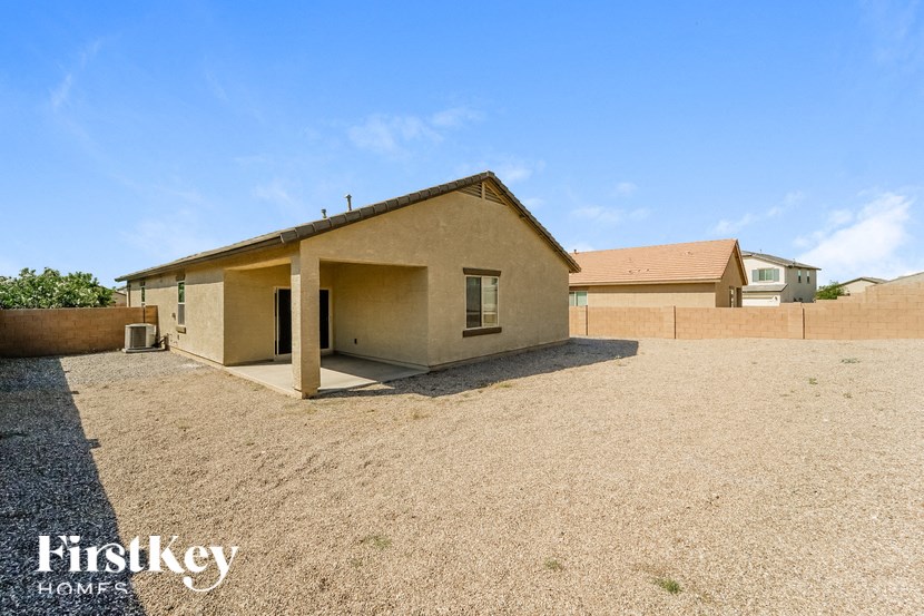 a home with a dirt lot and a house in the