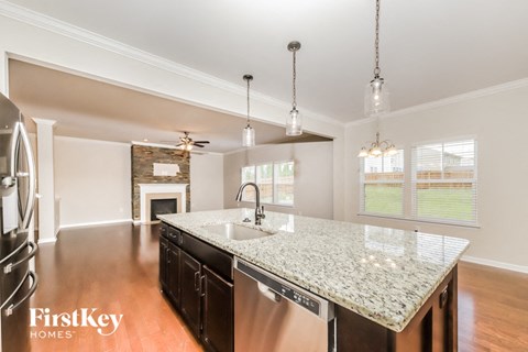 a kitchen with a marble counter top and a sink