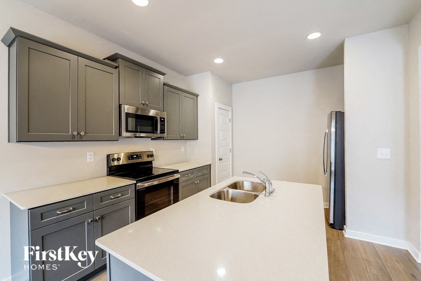 a kitchen with stainless steel appliances and a white counter top
