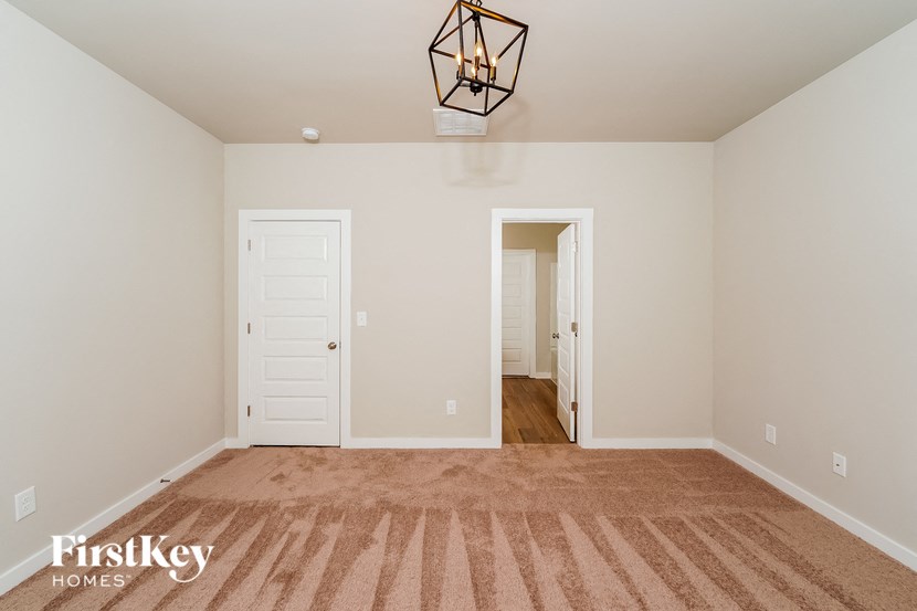 a bedroom with a closet and a door to a hallway
