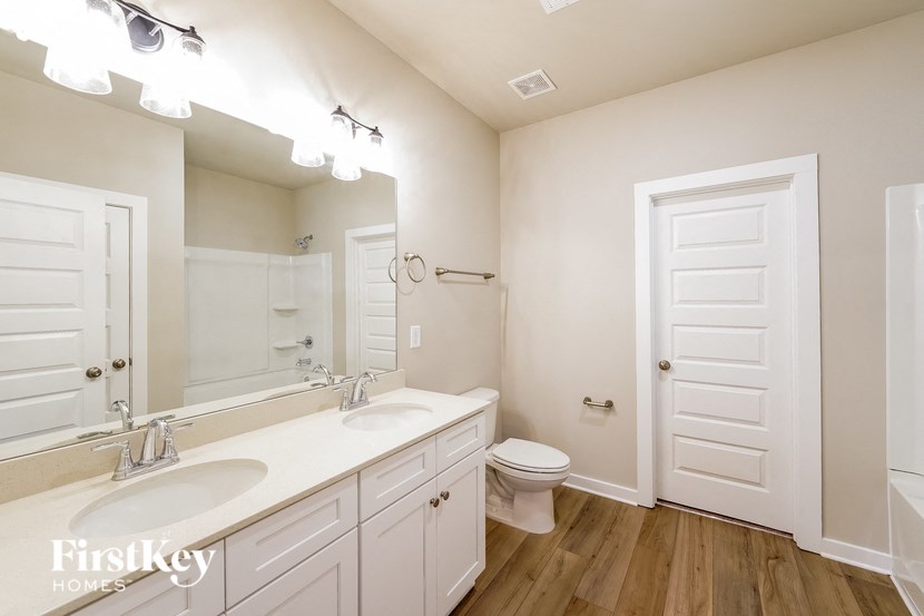 a bathroom with a toilet and a sink and a mirror
