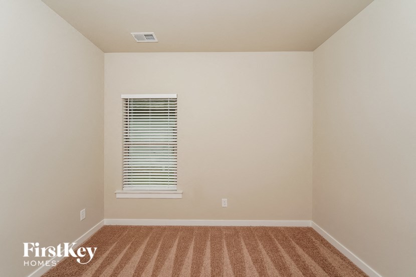 a empty room with a window and a rug