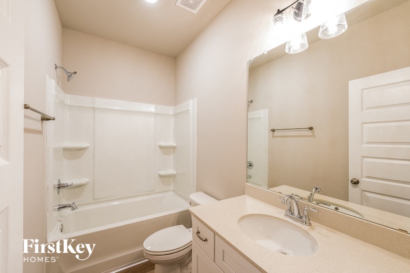 a bathroom with a sink toilet and a bath tub