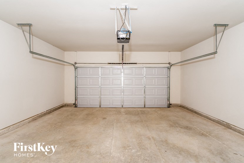 a empty garage with a white wall and a garage door