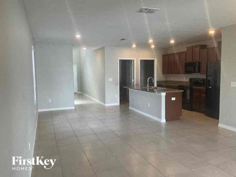 A kitchen area with a counter and cabinets.