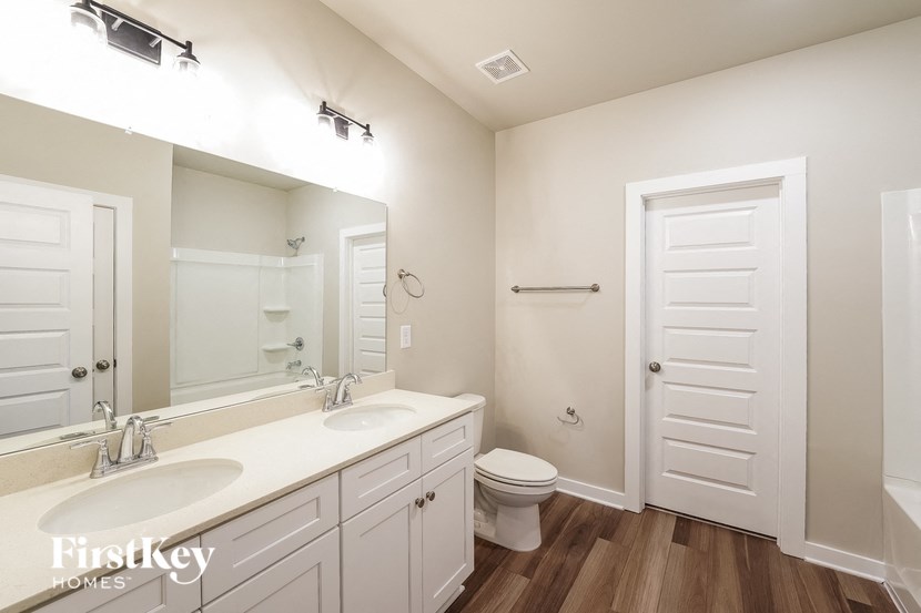 A bathroom with a white toilet and a white door.