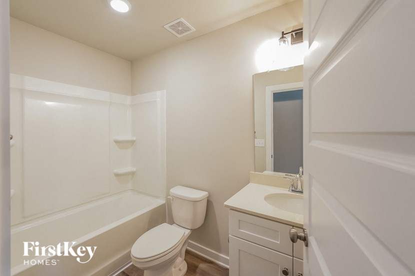 a bathroom with a toilet and a sink and a bath tub