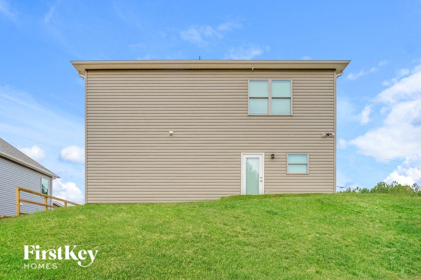 a tiny house on top of a grassy hill