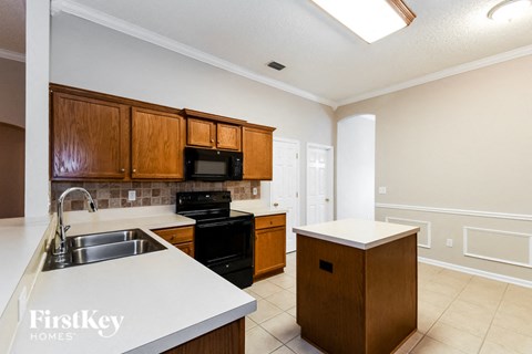A kitchen with wooden cabinets and a white countertop.