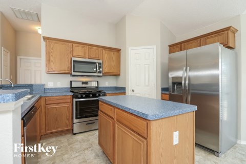 A kitchen with wooden cabinets and a blue countertop.