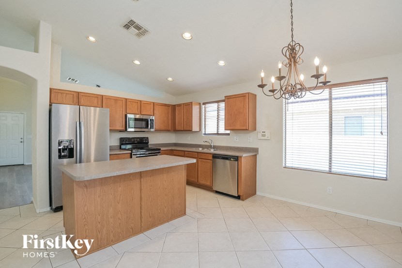 a large kitchen with wooden cabinets and stainless steel appliances