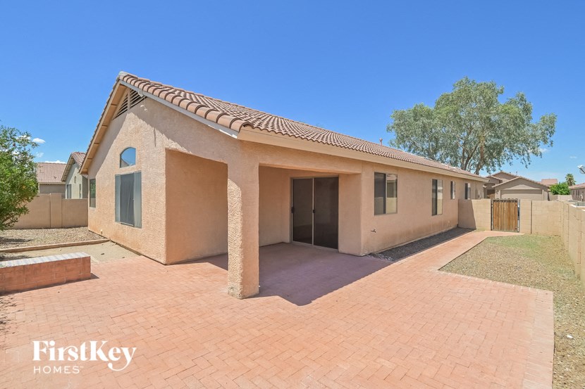 a brick house with a brick driveway and a garage