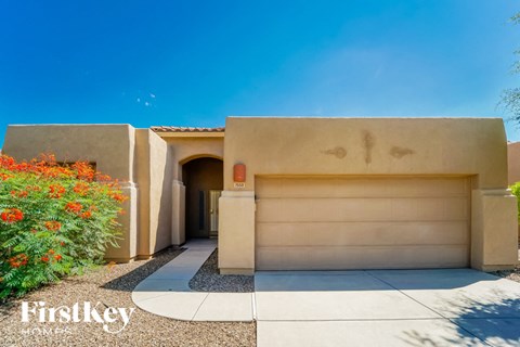 A house with a garage door and a logo that says "Firstkey" on the bottom left.